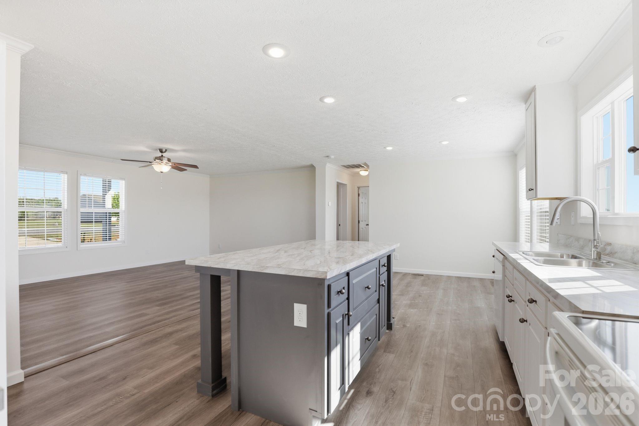 197 Burleson Point Woodleaf, NC 27054 - Photo 10 of 30 a kitchen with a sink and chandelier