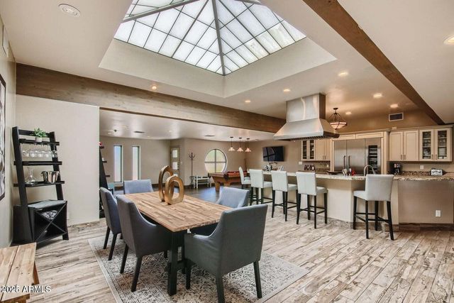a dining area with a table and chairs