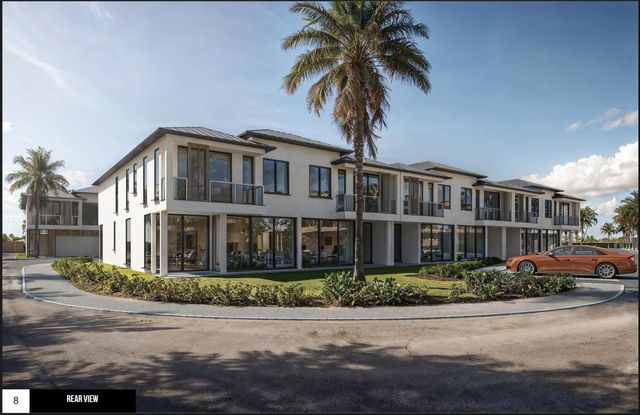 a front view of multiple houses with yard
