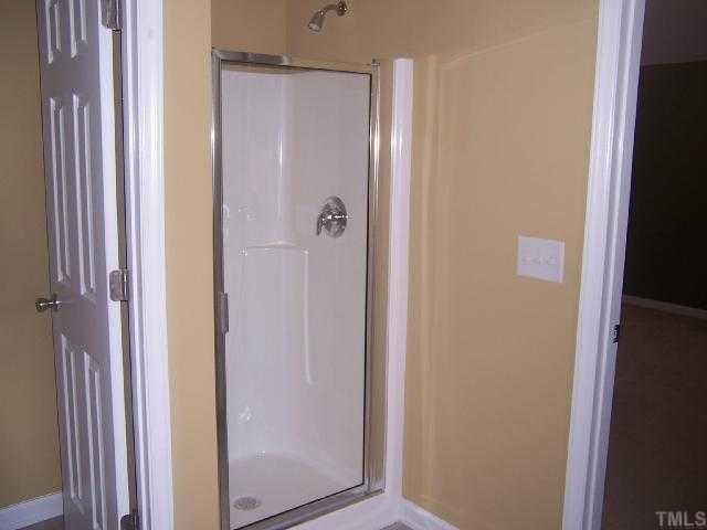 3718 Burtons Barn Street Raleigh, NC 27610 - Photo 9 of 9 a bathroom with a shower and a door