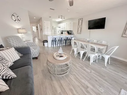 a kitchen with granite countertop a sink a stove and refrigerator