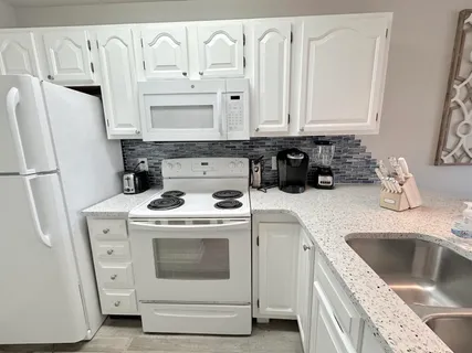 a large bed sitting in a bedroom next to a window