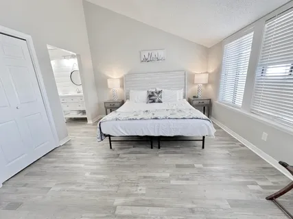 a room with a bed and wooden floor