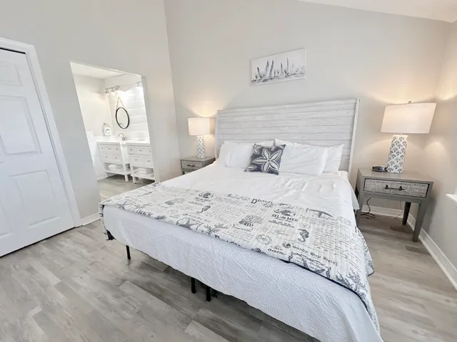 a bedroom with a bed and a wall painting