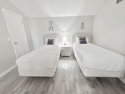 a view of a bedroom with wooden floor and staircase