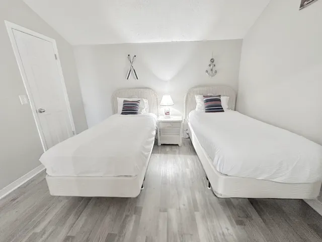 a view of a bedroom with wooden floor and staircase