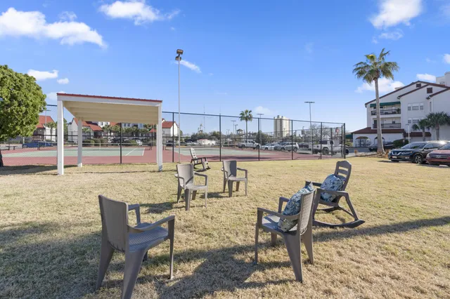 a view of houses with an outdoor space and seating area