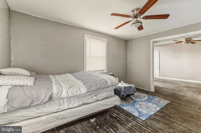 a bedroom with a bed and a ceiling fan