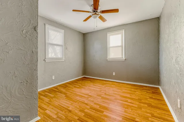 a view of a room with a ceiling fan and a window