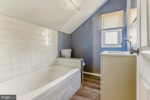 a bathroom with a bathtub and a sink