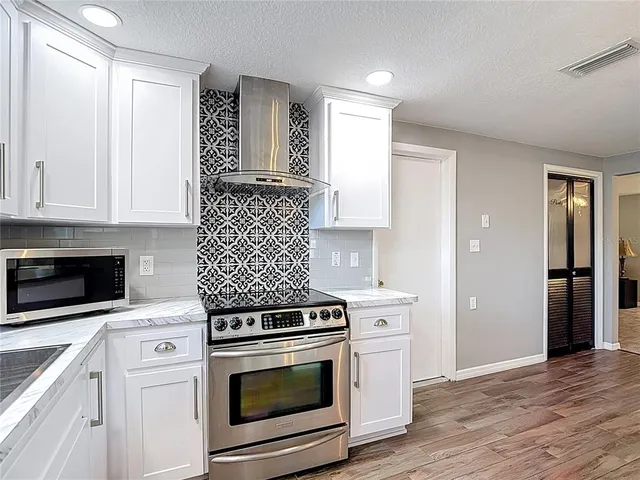 a kitchen with a stove and a sink