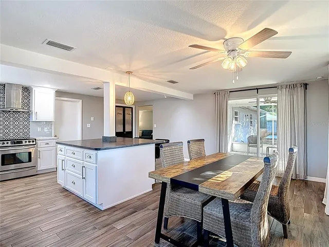 a large kitchen with kitchen island a island in the center