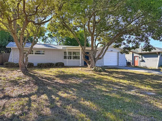a view of a house with pool and tree s