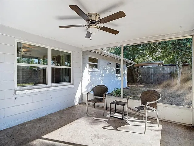 an aerial view of a residential houses with yard