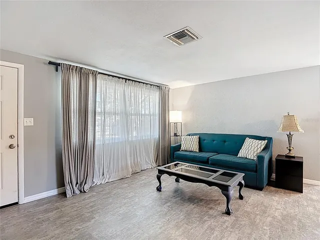 an empty room with fan and windows