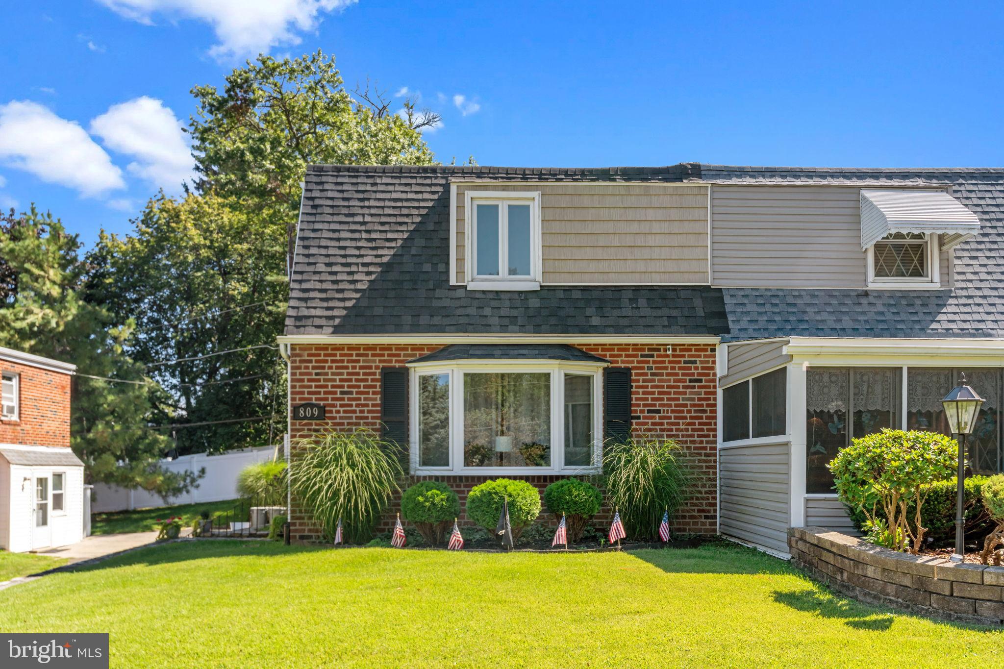 a view of a house with swimming pool next to a yard