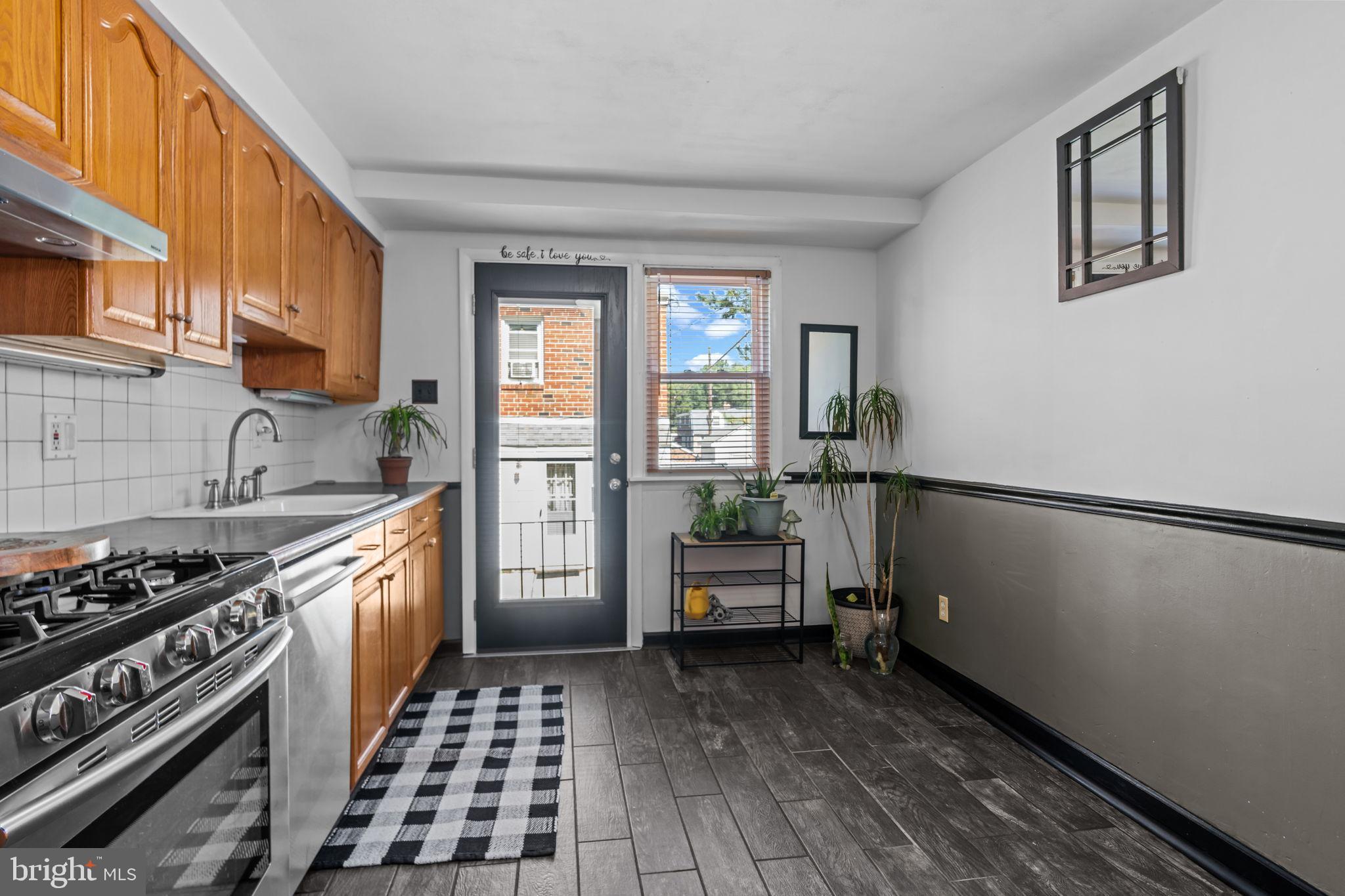 809 Millwood Road Philadelphia, PA 19115 - Photo 11 of 22 a kitchen with sink cabinets and stove