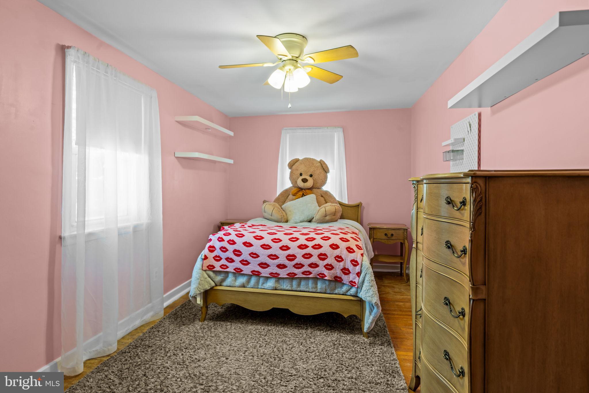 809 Millwood Road Philadelphia, PA 19115 - Photo 16 of 22 a bedroom with a bed and a chandelier