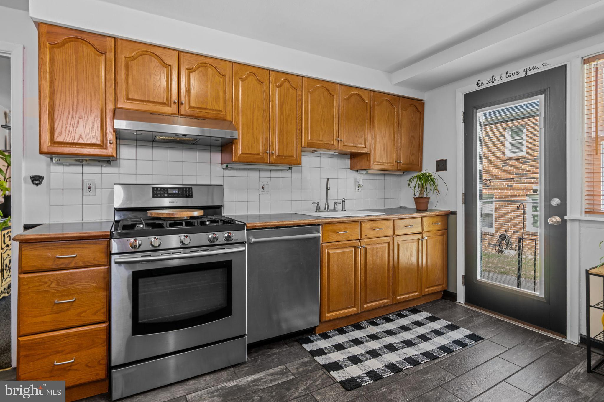 809 Millwood Road Philadelphia, PA 19115 - Photo 9 of 22 a kitchen with granite countertop wooden cabinets and stainless steel appliances