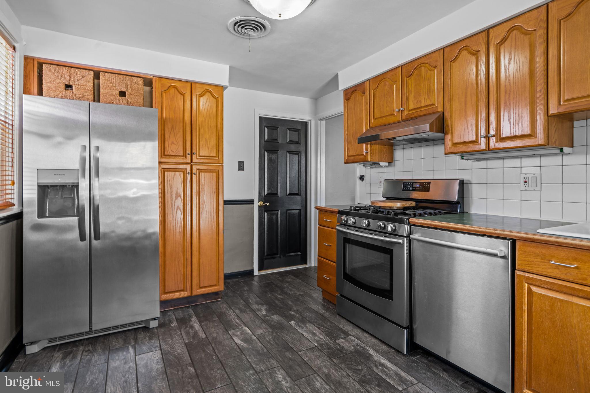 809 Millwood Road Philadelphia, PA 19115 - Photo 10 of 22 a kitchen with stainless steel appliances granite countertop a refrigerator stove and sink
