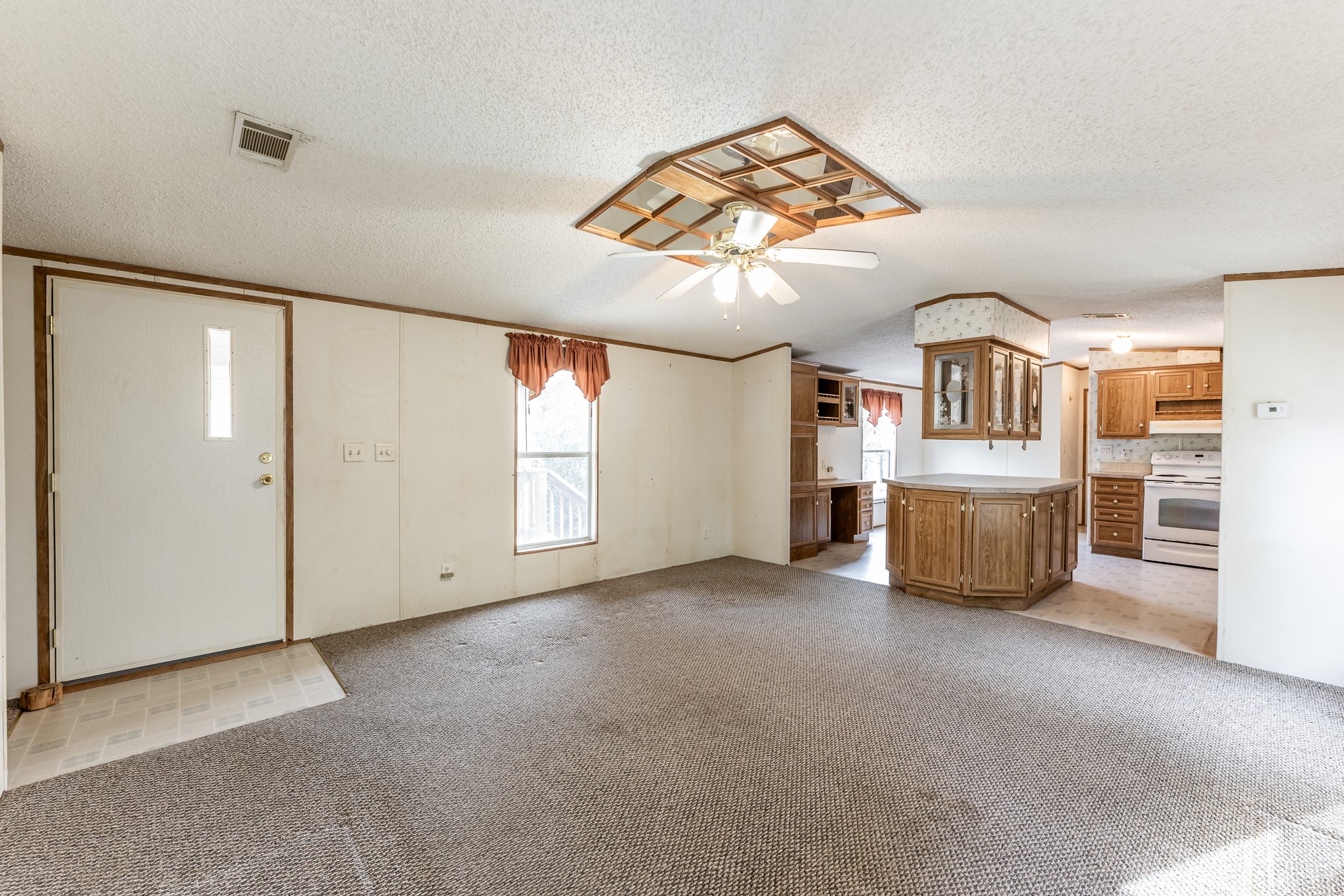 400 Marina Drive Trinity, TX 75862 - Photo 5 of 25 an empty room with chandelier fan and windows