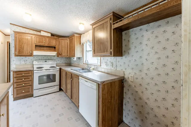 a kitchen with a sink stove and cabinets