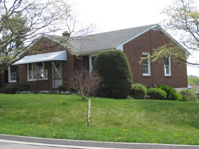 4656 Elva Road Northwest Roanoke, VA 24017 - Photo 1 of 10 a front view of a house with a yard
