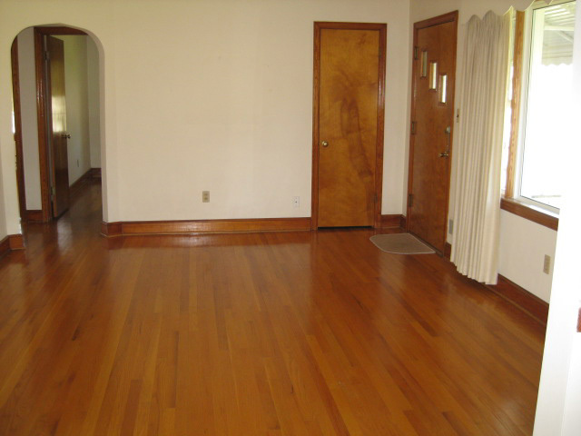 4656 Elva Road Northwest Roanoke, VA 24017 - Photo 4 of 10 a view of an empty room with wooden floor and a window