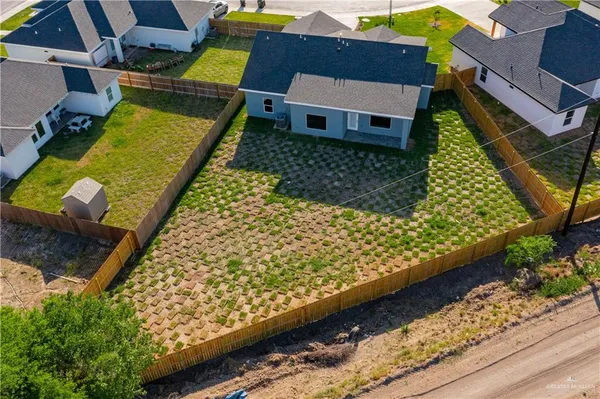 an aerial view of a house having a yard