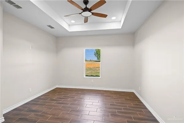 wooden floor in an empty room with a window