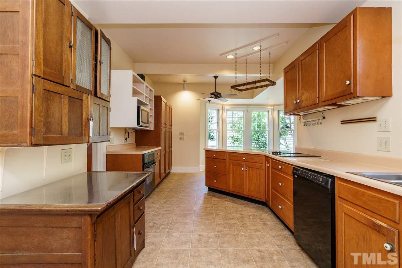 311 Hillcrest Road Raleigh, NC 27605 - Photo 11 of 30 a kitchen with stainless steel appliances granite countertop a sink a stove and a refrigerator