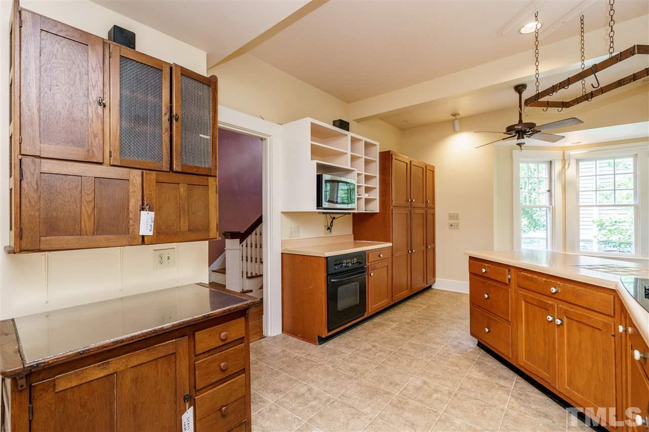 311 Hillcrest Road Raleigh, NC 27605 - Photo 12 of 30 a kitchen with stainless steel appliances granite countertop a sink and refrigerator