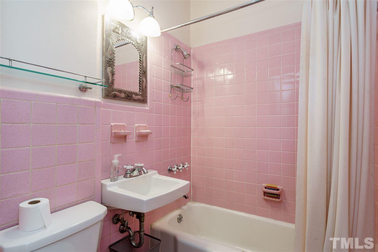 311 Hillcrest Road Raleigh, NC 27605 - Photo 18 of 30 a bathroom with a sink a toilet a mirror and bathtub