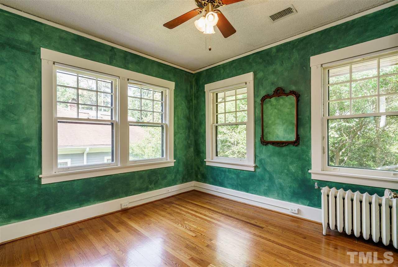 311 Hillcrest Road Raleigh, NC 27605 - Photo 22 of 30 a view of empty room with wooden floor and fan