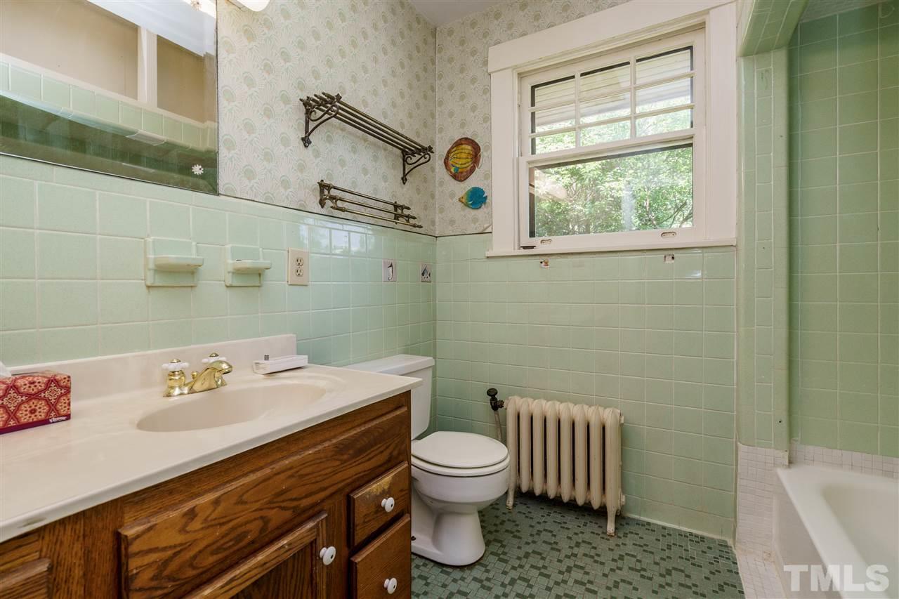 311 Hillcrest Road Raleigh, NC 27605 - Photo 23 of 30 a bathroom with a sink a toilet and a shower