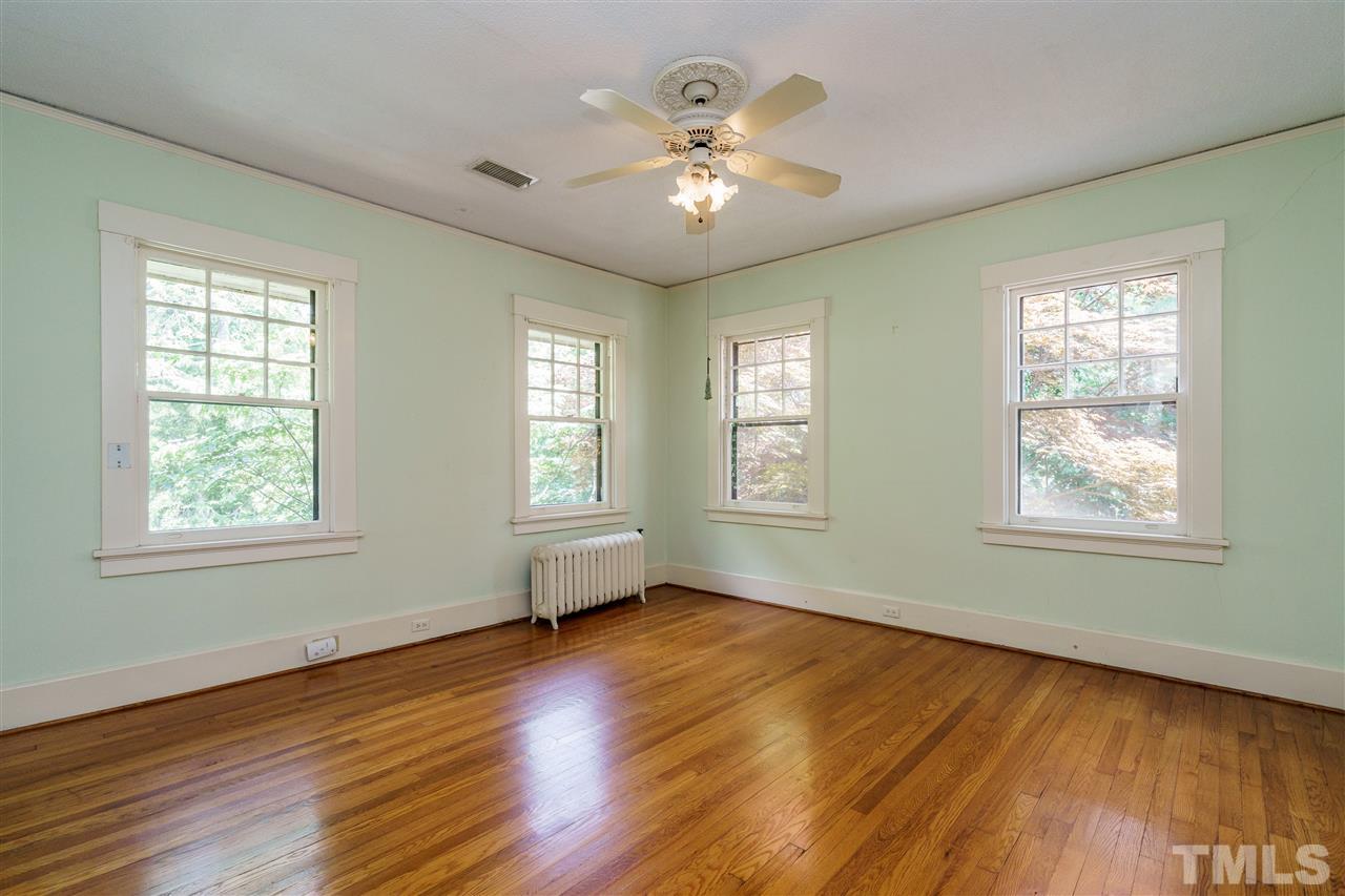 311 Hillcrest Road Raleigh, NC 27605 - Photo 24 of 30 a view of an empty room with wooden floor and a window