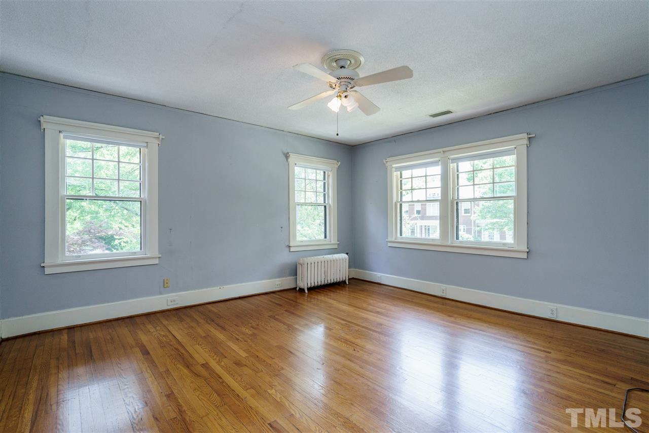 311 Hillcrest Road Raleigh, NC 27605 - Photo 25 of 30 a view of an empty room with wooden floor and a window
