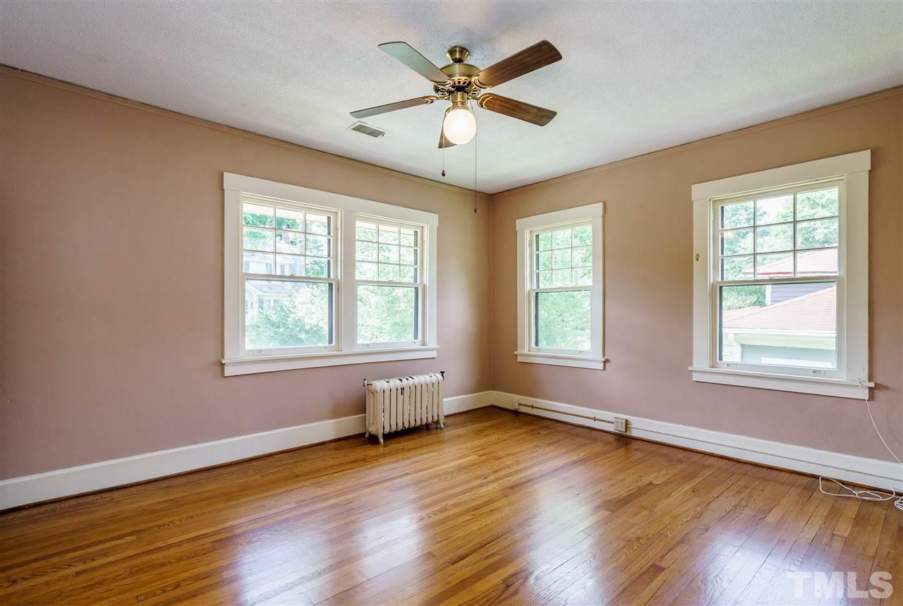 311 Hillcrest Road Raleigh, NC 27605 - Photo 26 of 30 a view of an empty room with wooden floor and a window