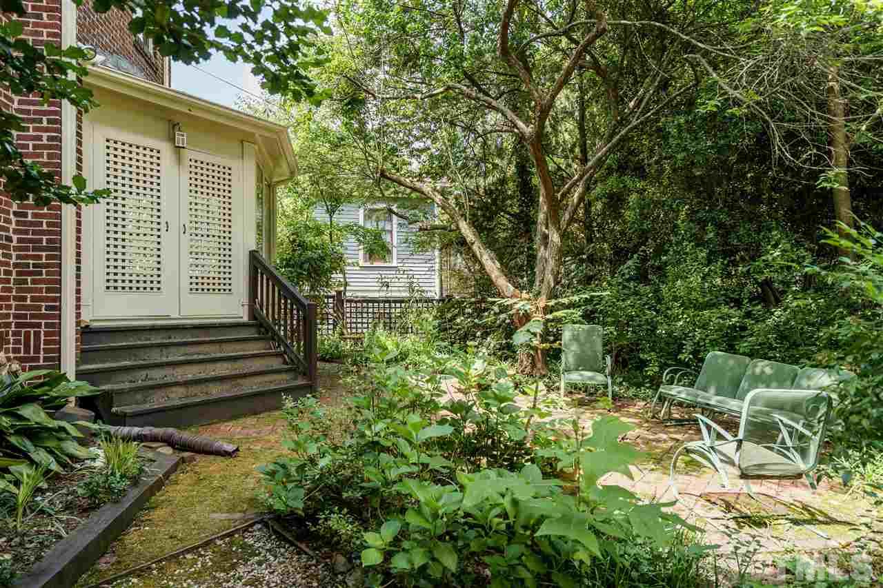 311 Hillcrest Road Raleigh, NC 27605 - Photo 27 of 30 a view of a house with a yard and sitting area