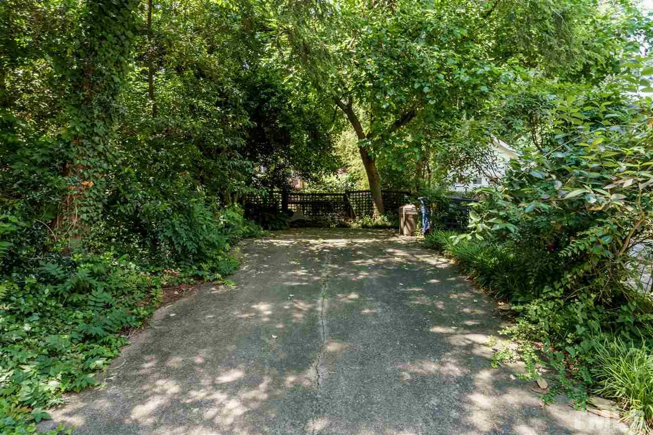 311 Hillcrest Road Raleigh, NC 27605 - Photo 29 of 30 a view of a yard with plants and a trees