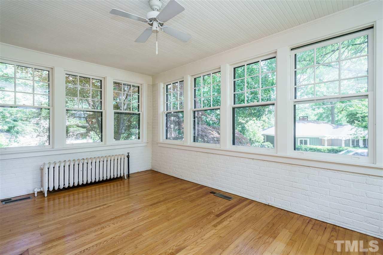 311 Hillcrest Road Raleigh, NC 27605 - Photo 7 of 30 a view of an empty room with wooden floor and a window