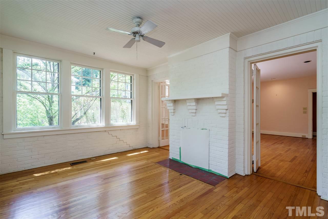 311 Hillcrest Road Raleigh, NC 27605 - Photo 8 of 30 wooden floor in an empty room with a window