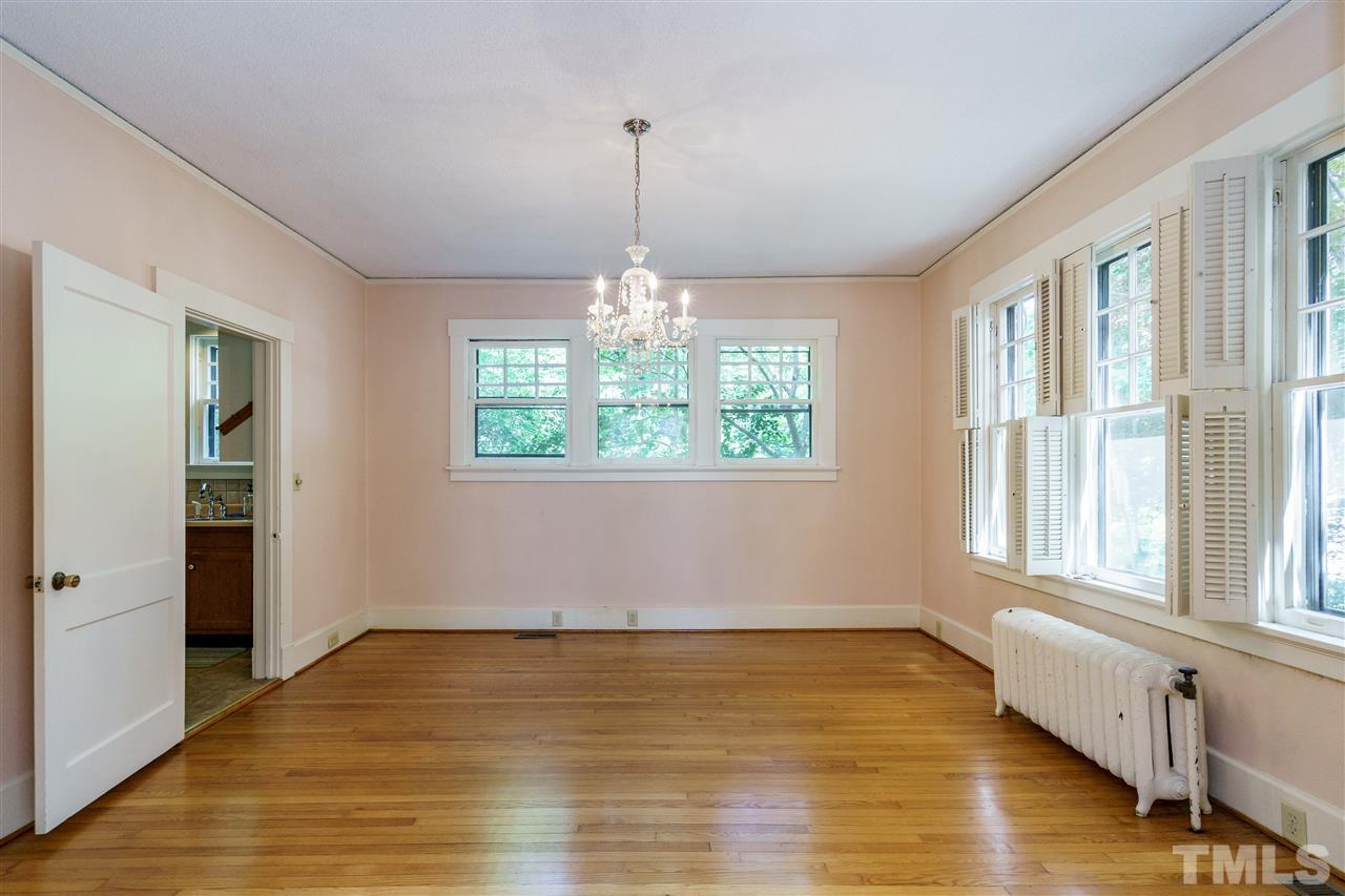 311 Hillcrest Road Raleigh, NC 27605 - Photo 9 of 30 an empty room with wooden floor and windows
