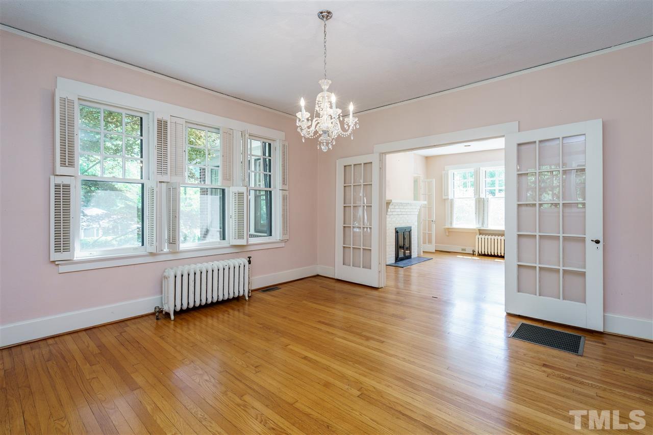 311 Hillcrest Road Raleigh, NC 27605 - Photo 10 of 30 a view of an empty room with window and wooden floor