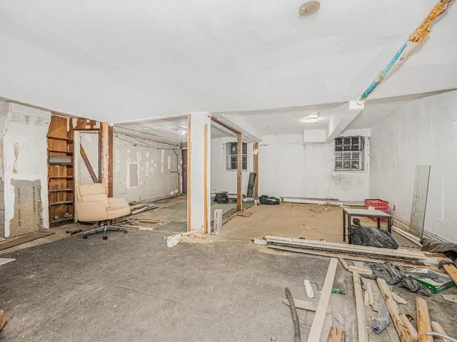 a view of a livingroom with wooden floor and a sink