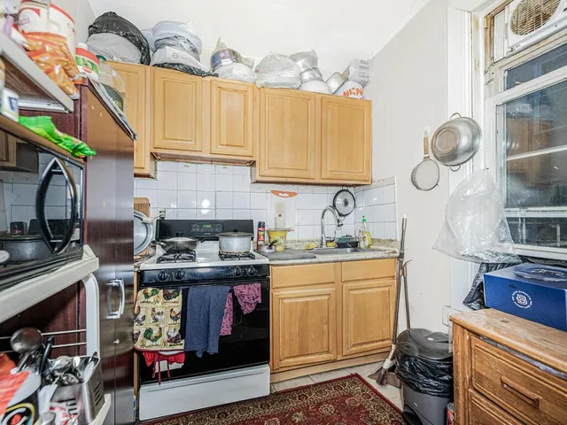 a kitchen with stainless steel appliances granite countertop a stove and cabinets