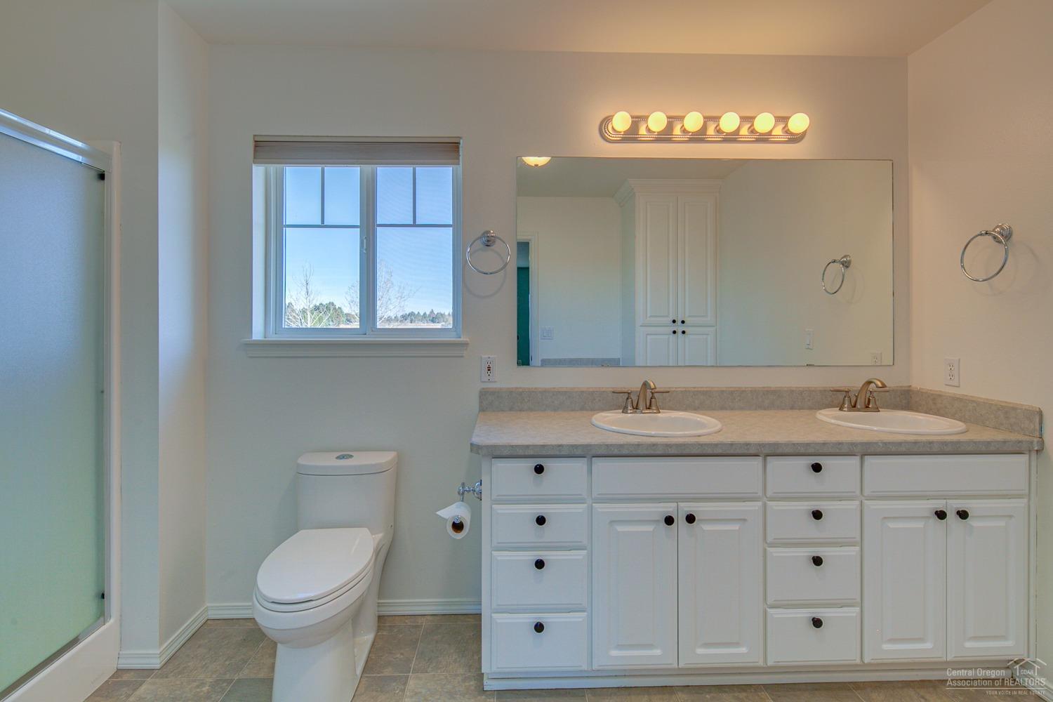 61490 Ward Road Bend, OR 97702 - Photo 21 of 25 a bathroom with a toilet a sink and mirror