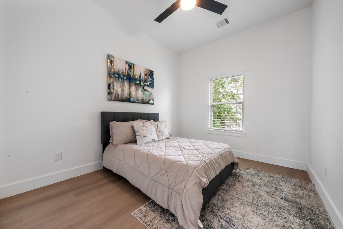 6815 Paris Street Houston, TX 77021 - Photo 19 of 30 a large bed sitting in a bedroom next to a window