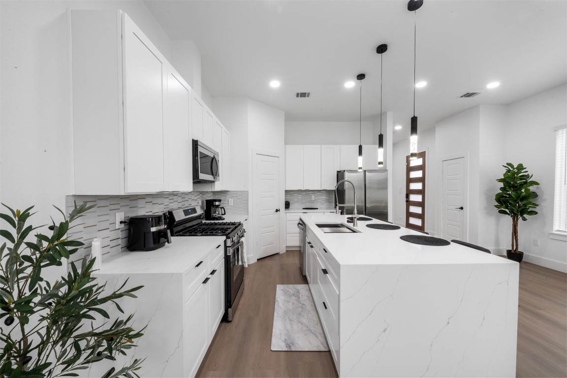 6815 Paris Street Houston, TX 77021 - Photo 28 of 30 a kitchen with a sink a stove and a refrigerator