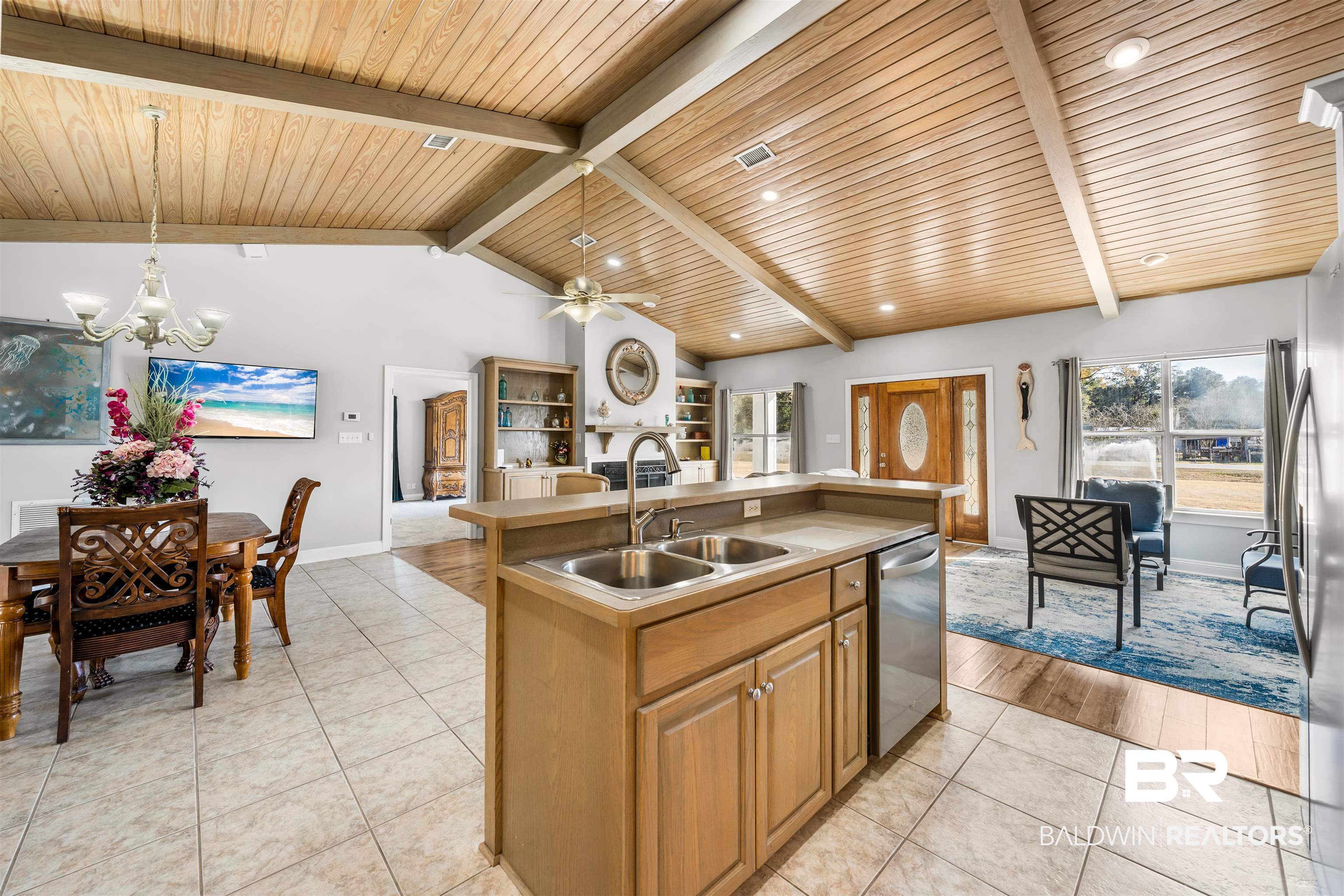 19079 Baldwin County Road 10 Foley, AL 36535 - Photo 37 of 37 Kitchen featuring a kitchen island with sink, wood finish cabinetry, ceiling fan, light tile patterned floors, and open floor plan